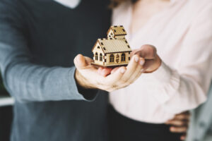 crop-couple-holding-toy-house